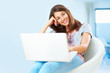 Woman with an attractive smile using laptop