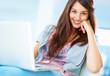 Young girl sitting on chair using laptop
