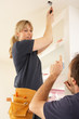 Electrician Teaching Apprentice To Install Light Fitting In Home