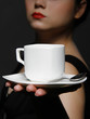 woman holding a cup of black coffee