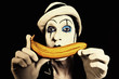 mime in white hat holding a banana in his hand