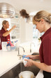 Team Of Commercial Cleaners Working In Domestic Kitchen