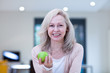 Mature woman eating an apple