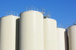 Refinery oil storage tanks and blue sky in background