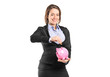 A businesswoman putting a coin into a piggy bank A businesswoman putting a coin into a piggy bank