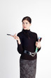 Young beautiful woman with magazine and pen standing tall