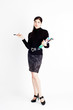 Young beautiful woman with magazine and pen standing tall