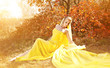 Foto: Young beautiful girl in a yellow dress in the woods Young beautiful girl in a yellow dress in the woods