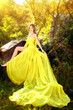 Young beautiful girl in a yellow dress in the woods