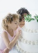 Girls looking at wedding cake