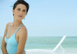 Woman on beach, lounge chair in background