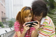 Young couple playing portable video game