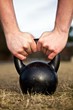Closeup of hands lifting a heavy kettlebell