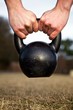 Closeup of hands lifting a heavy kettlebell