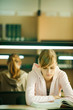 Young woman studying in university library