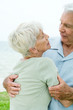Senior couple talking, man holding woman in his arms