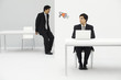 Photo: Young professional sitting in office, looking at megaphone, colleague in the next room, shouting Young professional sitting in office, looking at megaphone, colleague in the next room, shouting