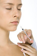 Woman receiving Botox injection, eyes closed, close-up