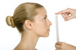 Woman in profile, face being measured by ruler