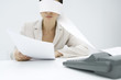 Photo: Woman sitting at desk, tape from an adding machine wrapped around her head, holding document Woman sitting at desk, tape from an adding machine wrapped around her head, holding document