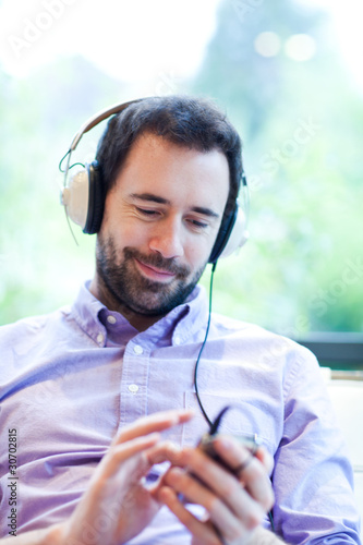Photo: Man listening to music with MP3 player Man listening to music with MP3 player