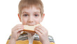 Boy tasting piece of bread