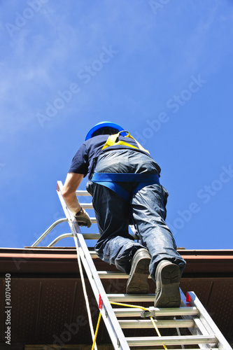 Photo: Construction worker climbing ladder Construction worker climbing ladder