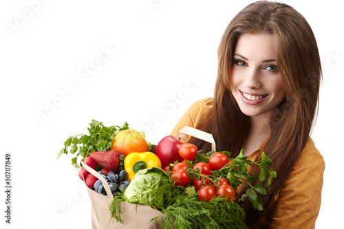 Photo: woman holding a bag full of healthy food. shopping . woman holding a bag full of healthy food. shopping .