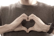 Man Making Heart Shape with Hands Near Chest Man Making Heart Shape with Hands Near Chest