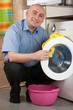 man loading the washing machine