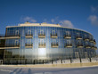 Hotel on the frozen lake shore. Serene day, winter season