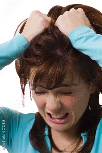Photo: Woman Holding Head In Anguish Woman Holding Head In Anguish