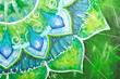 closeup of bright green painted picture with circle pattern, man