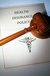 health insurance policy and law gavel