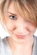 Close-up of beautiful attractive woman, sly glance, smiling
