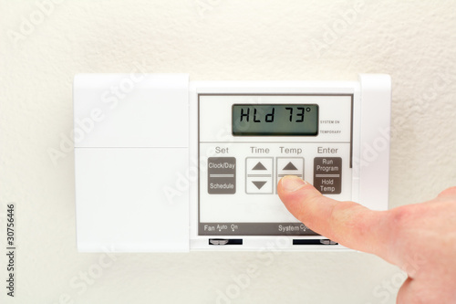 Photo: Hand on Thermostat Hand on Thermostat