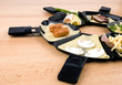 Raclette pans with food, ideal for party