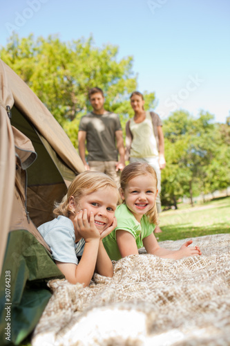 Photo: Happy family camping in the park Happy family camping in the park