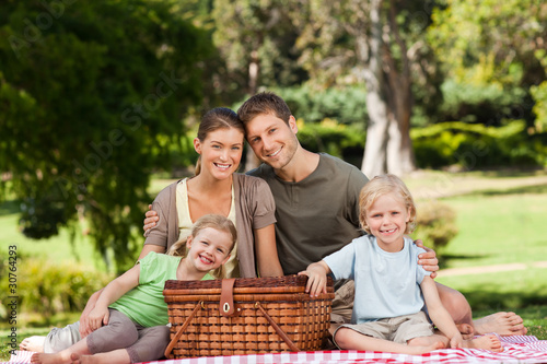 Photo: Joyful family picnicking in the park Joyful family picnicking in the park