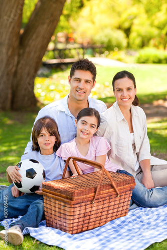 Photo: Happy family picnicking in the park Happy family picnicking in the park