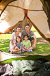 Joyful family camping in the park