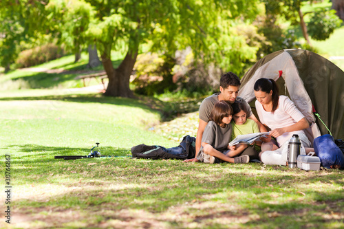Photo: Joyful family camping in the park Joyful family camping in the park