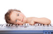 Little boy lie on piano keyboard Little boy lie on piano keyboard