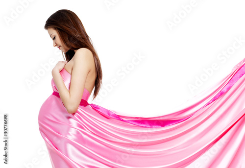 Photo: Pregnant woman in rosy dress isolated on white Pregnant woman in rosy dress isolated on white