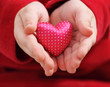 Child holds satin valentine heart Child holds satin valentine heart