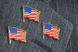 Three American flag pins on a pinstripe suit lapel