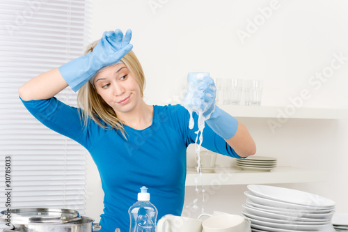 Photo: Modern kitchen - frustrated woman washing dishes Modern kitchen - frustrated woman washing dishes