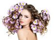 Flowers in long hair of beautiful and sexy woman