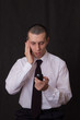 young businessman talking on two phones young businessman talking on two phones