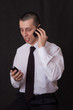 young businessman talking on two phones young businessman talking on two phones